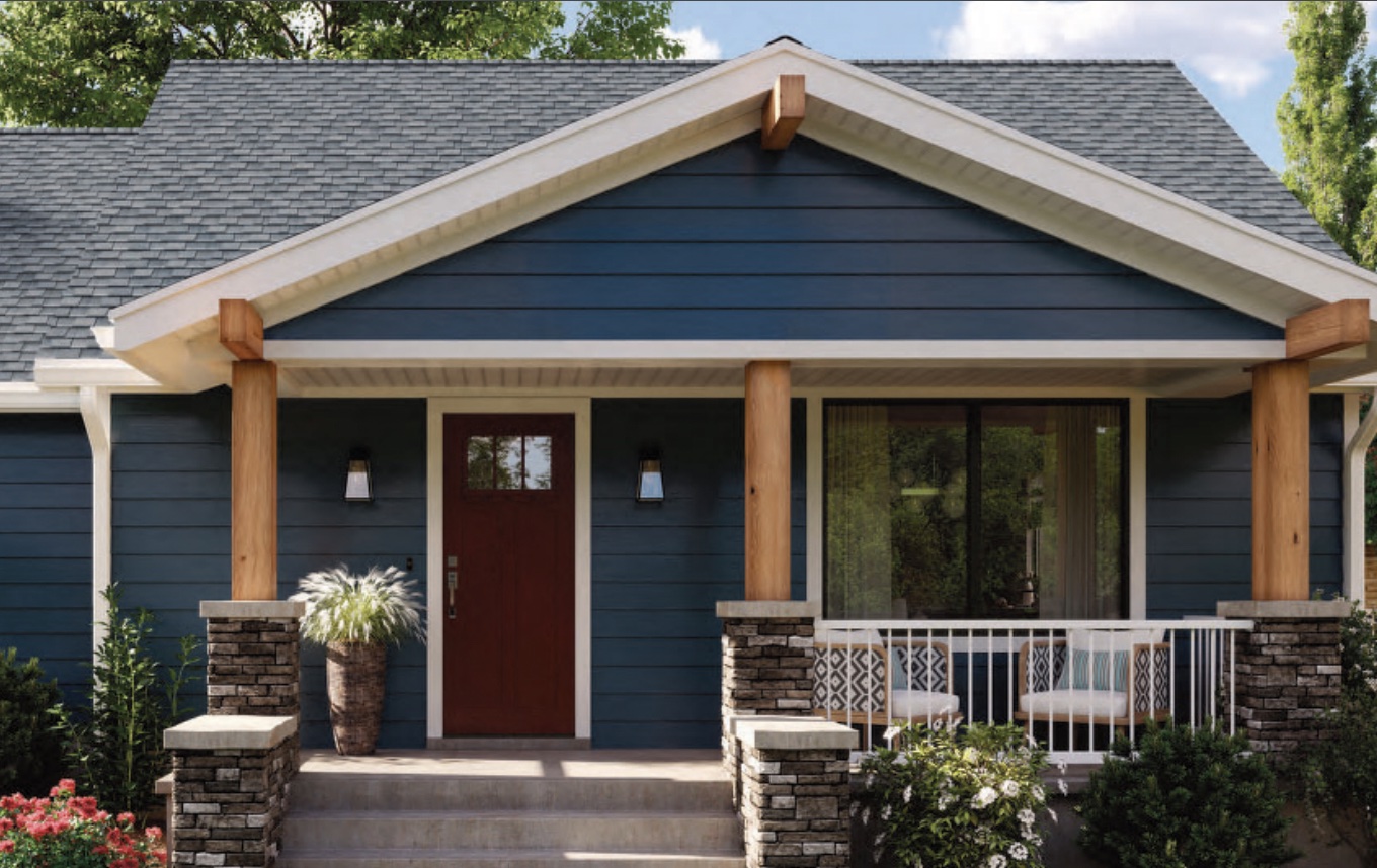 Cute Acadian Style Home in dark blue with wooden columns.